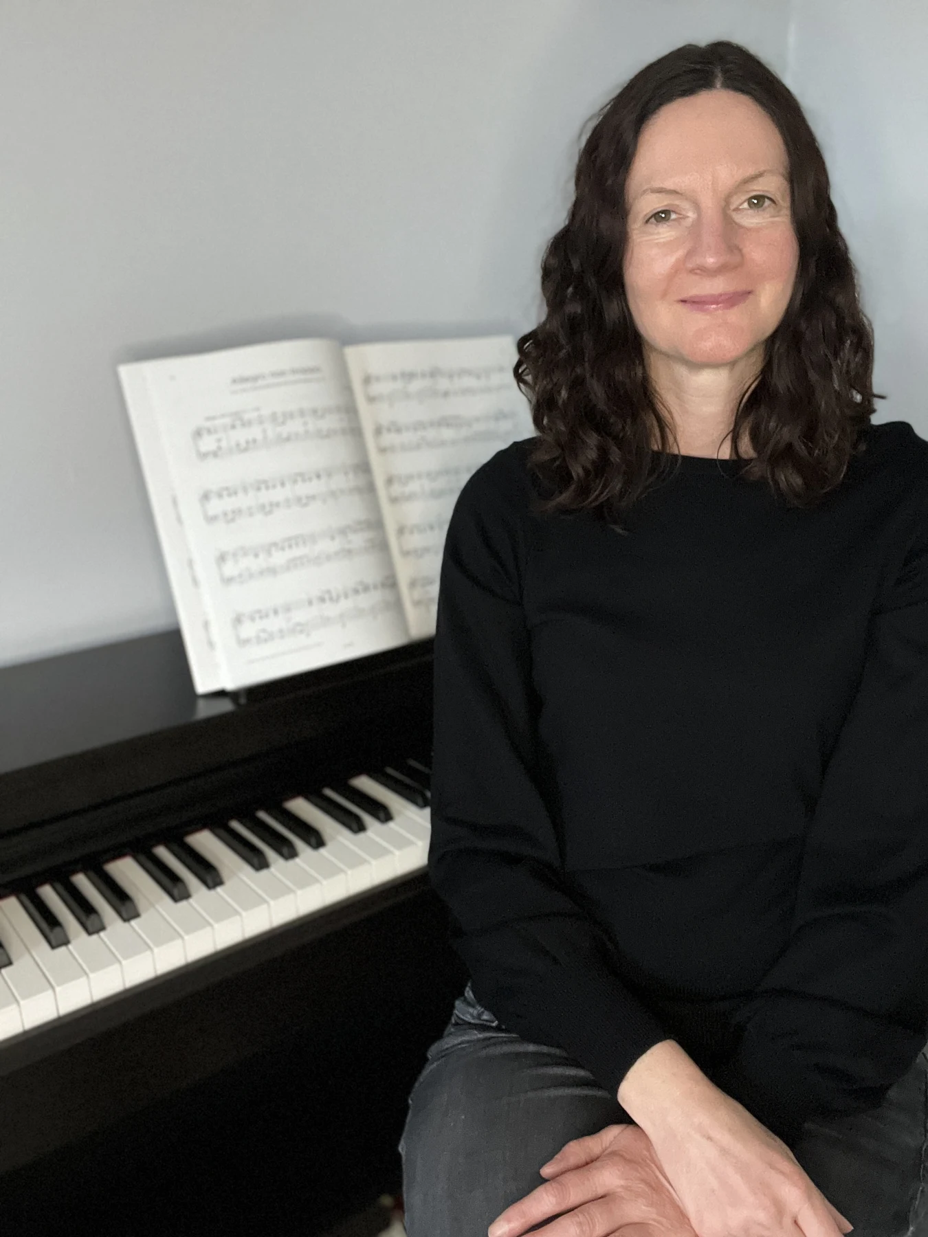 Lisa Cutts beside her piano